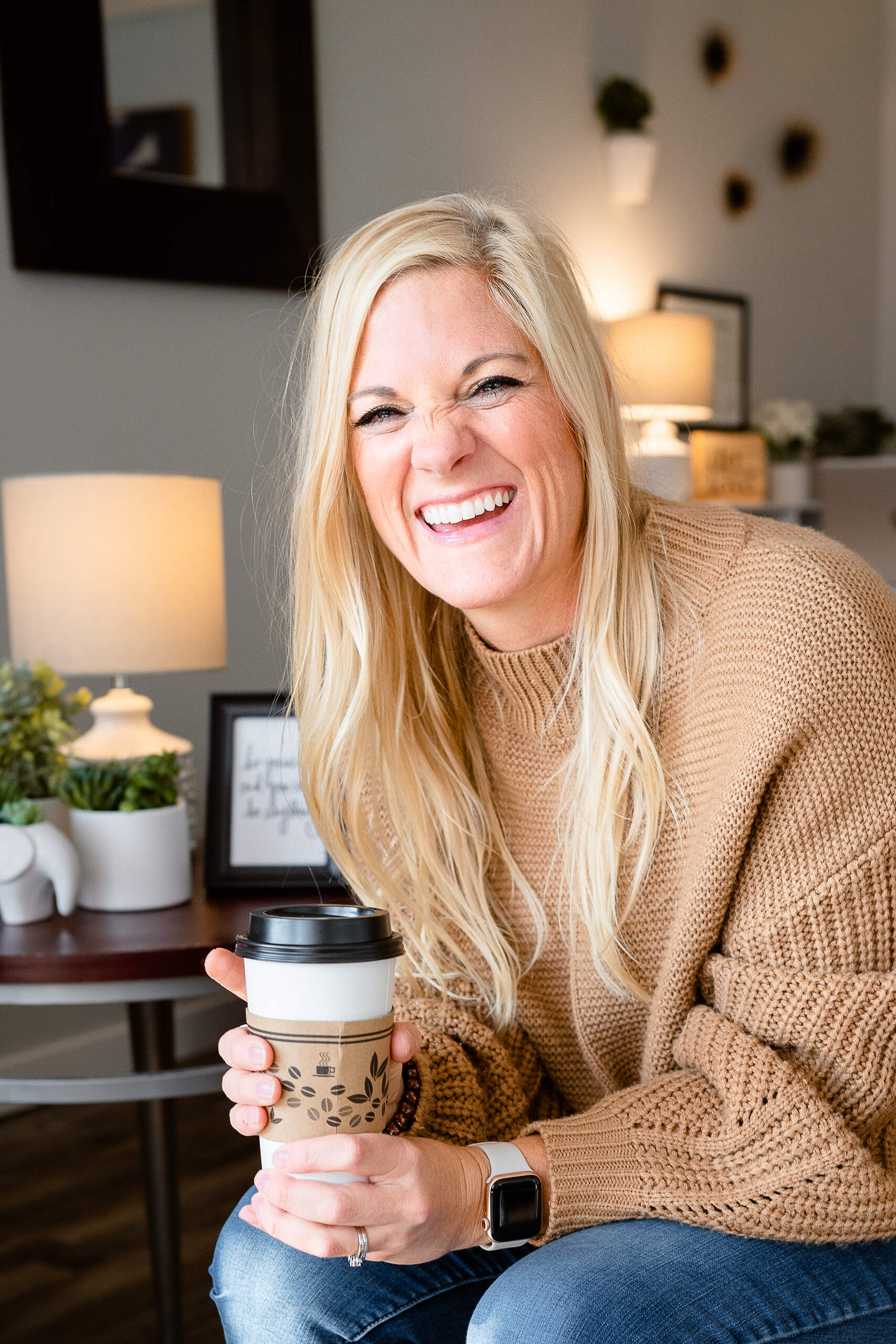 Photo of Ronna in office holding coffee